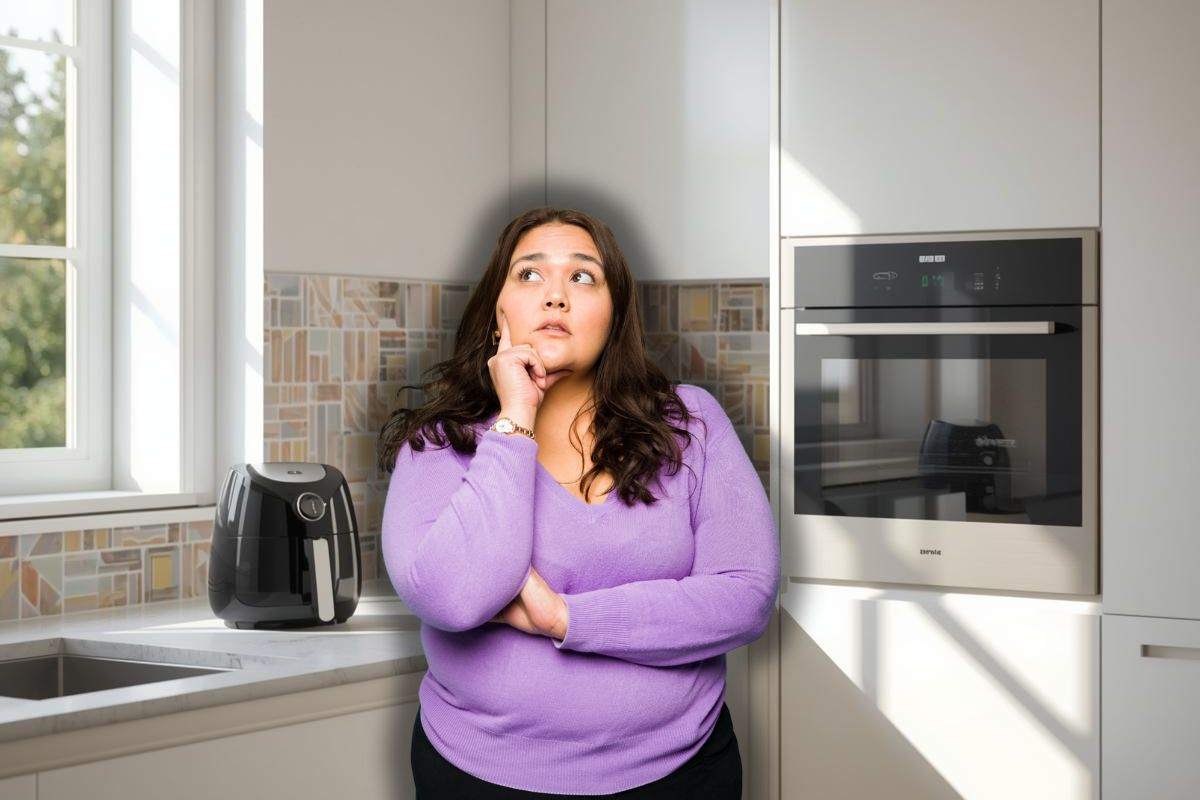 friggitrice ad aria e forno elettrico in cucina e donna che pensa